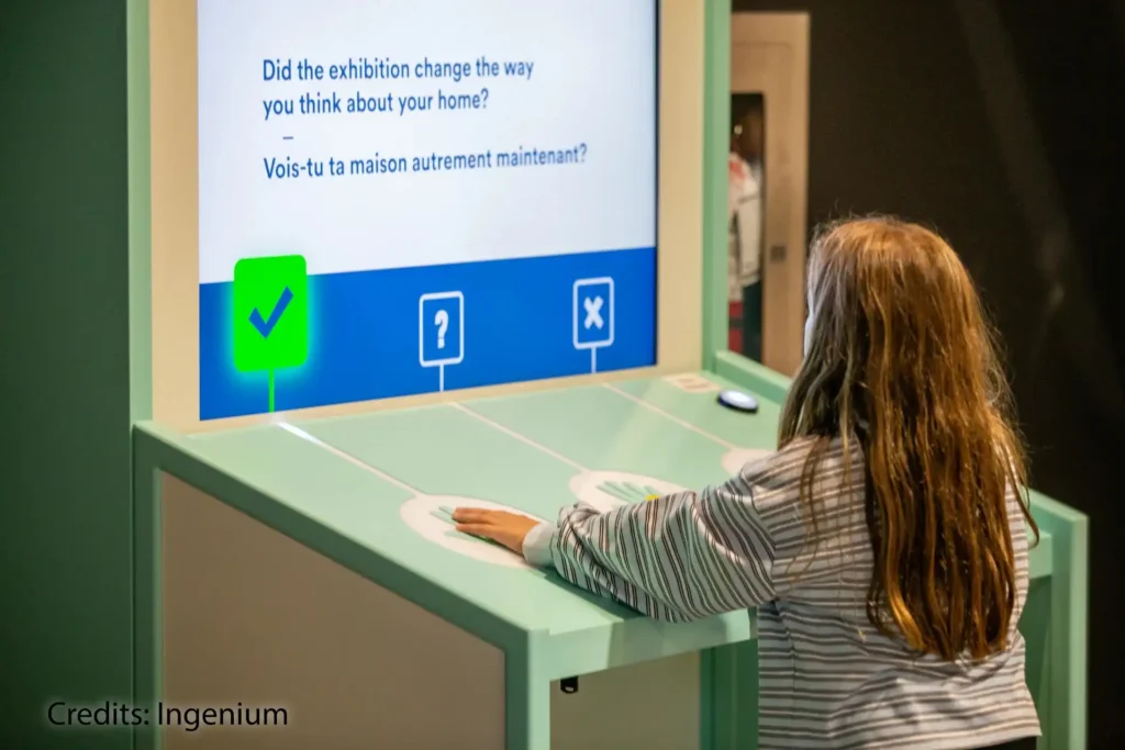Kid interacting with Impact Station at Inside the Walls Exhibition